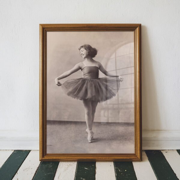 Elegant vintage black and white portrait of a graceful ballerina standing en pointe in a classic tutu.