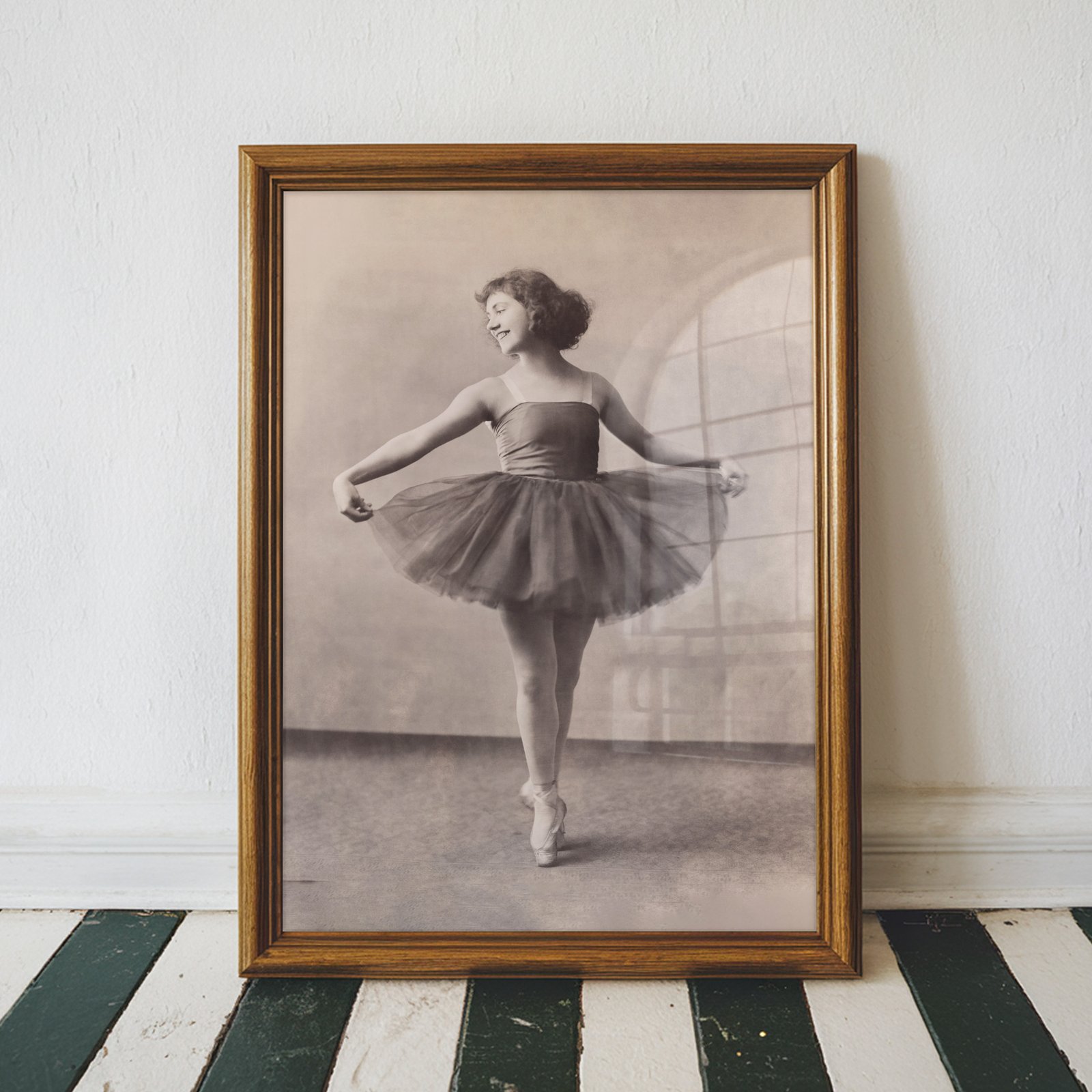 Elegant vintage black and white portrait of a graceful ballerina standing en pointe in a classic tutu.