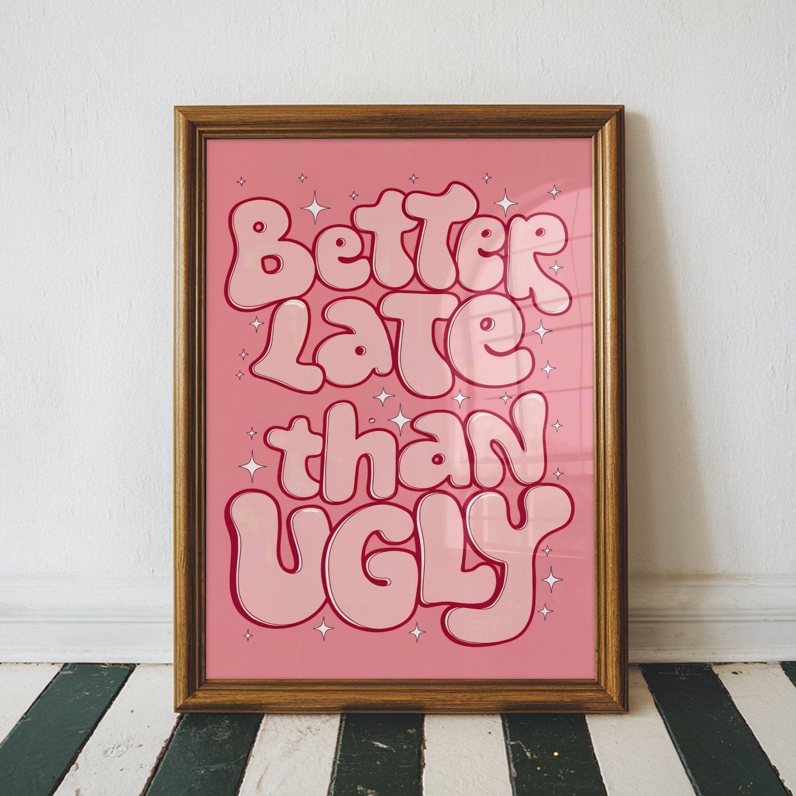 Pink retro typography wall art featuring the quote "Better Late Than Ugly" in bold bubble letters with sparkles, framed as modern feminine bedroom decor.